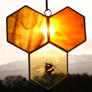 A delicate hand painted honey bee & honeycomb suncatcher. Gold amber honey swirls of stained glass. A unique mother nature inspired bee gif